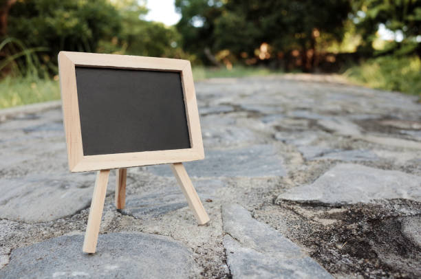 istock Close up Little Wooden Chalkboard on Stone way 1164882578