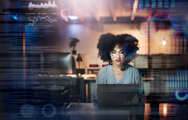 Getting lost in the code Shot of a young female programmer using a laptop while working late in her office computer technology people stock pictures, royalty-free photos & images