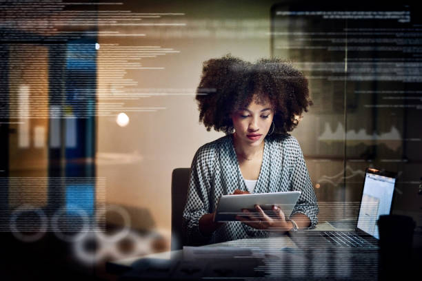 Making a few adjustments to the code Shot of a young female programmer using a digital tablet while working late in her office big tech photos stock pictures, royalty-free photos & images