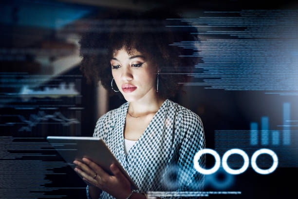 One touch can connect you to everything Shot of a young female programmer using a digital tablet while working late in her office digital enhancement stock pictures, royalty-free photos & images