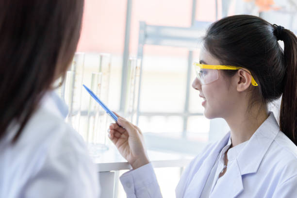 istock Asian young female working and research scientist together. 1164885804