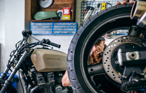 istock Mechanic fixing custom motorcycle wheel 1164885847