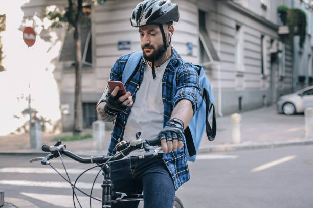 istock Delivery man on a cargo bike, looking for the right direction 1164888440