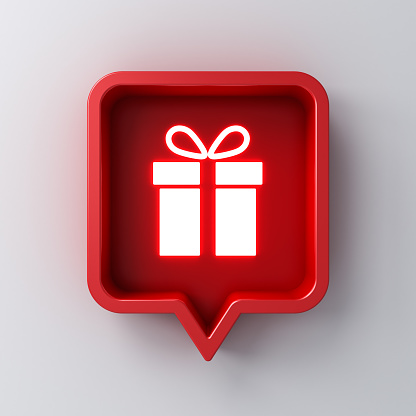 Neon light gift icon in red social media notification speech bubble box pin isolated on dark white wall background with shadow 3D rendering