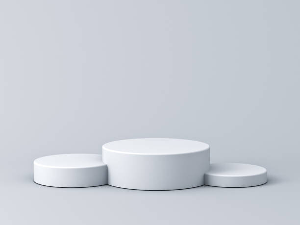 istock Blank white podium isolated on gray background with shadows 1164889707
