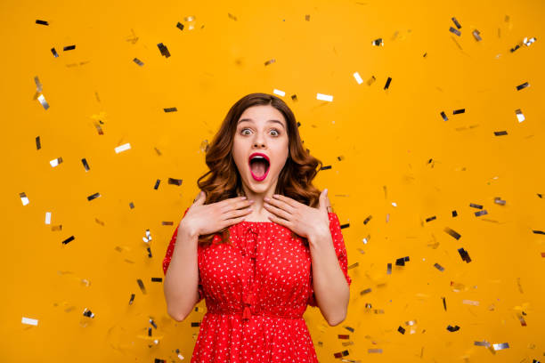 Pretty lady surprised by unexpected birthday party arranging wear red dress isolated yellow background Pretty lady surprised by unexpected, birthday party arranging wear red dress isolated yellow background excited woman yellow stock pictures, royalty-free photos & images