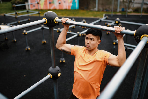 istock Chinese young man exercising on cloudy day, doing push ups 1164893786