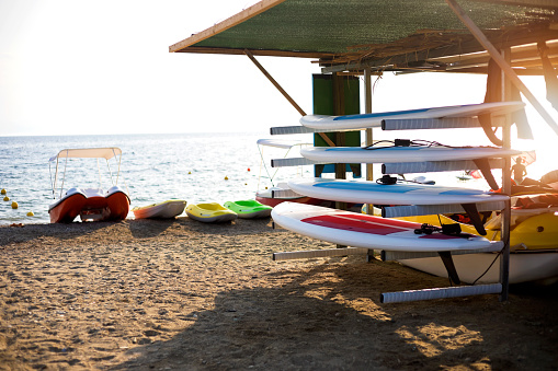 Surfing and paddling boards and equipment for water sport on the beach