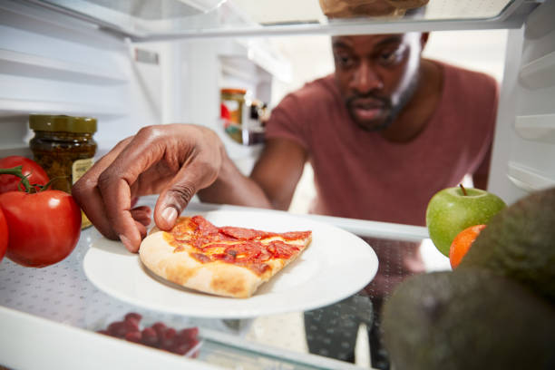 istock View Looking Out From Inside Of Refrigerator As Man Opens Door For Leftover Takeaway Pizza Slice 1164895460