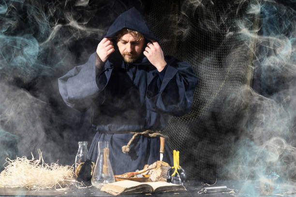 istock The medieval alchemist make magic ritual at the table in his smoke laboratory. 1164896865