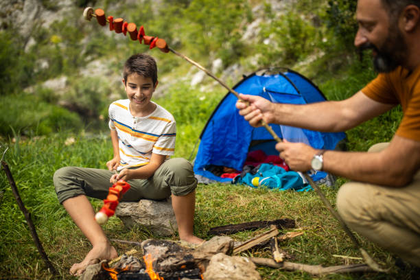 istock Father and son making barbecue on camping 1164898541