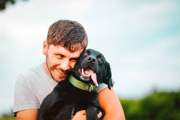 istock Guy and his dog having a fun in the nature 1164898607
