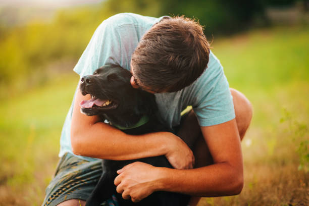 istock Guy and his dog having a fun in the nature 1164900120