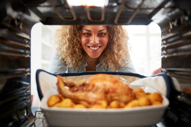 istock View Looking Out From Inside Oven As Woman Cooks Sunday Roast Chicken Dinner 1164901189