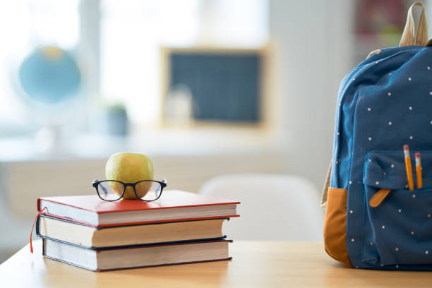 istock Apple, pile of books and backpack 1164902896