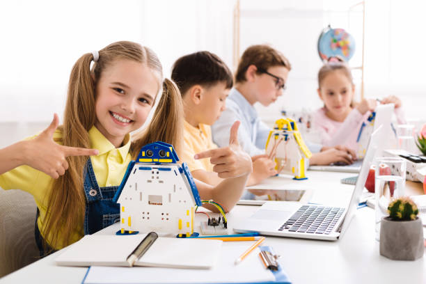 istock Girl showing her robot. Proud student of her project 1164904046