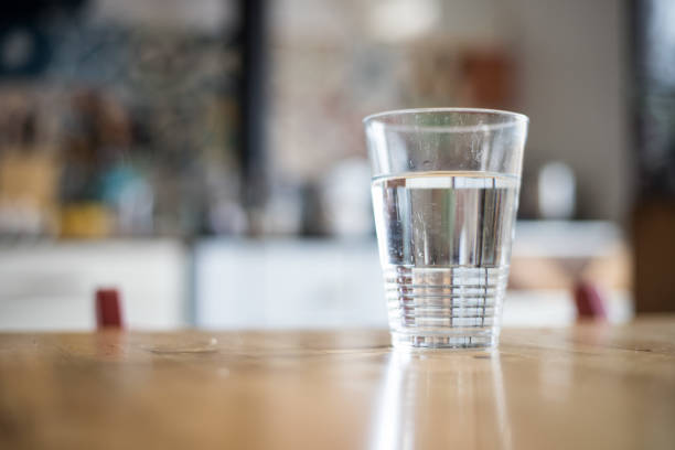 istock Clear glass of fresh, cold water on the kitchen table 1164904171