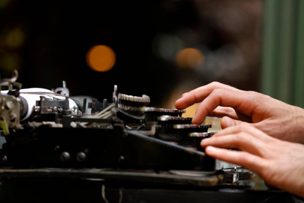 istock Hand of a young men writer writing on antique typewriter 1164906021