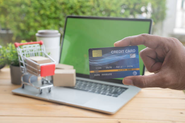 istock Hands holding credit card and using laptop. Online shopping concept. 1164908029