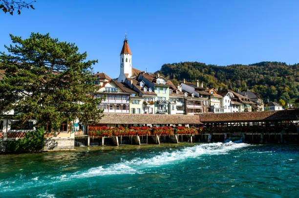 city view of thun, with old and historical houses next to river aare. canton bern, switzerland - berne berne canton aare river switzerland imagens e fotografias de stock