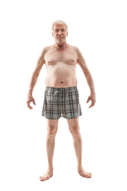Elderly naked man Elderly man posing in the studio in the nude cut out on a white background fat guy no shirt stock pictures, royalty-free photos & images