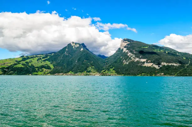 Thunersee (Thuner see), lake of Thun. View on alps mountains Burgfeldstand and Sigriswiler Rothorn and village Merligen. Faulensee nearby Spiez, Canton Bern, Switzerland.