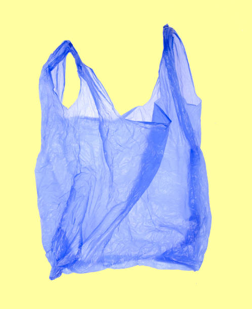 istock Blue plastic shopping bag on yellow background. 1164910310