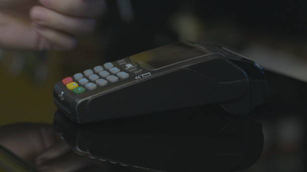 istock Close-up shot of person using mobile payment PayPass. 1164910517