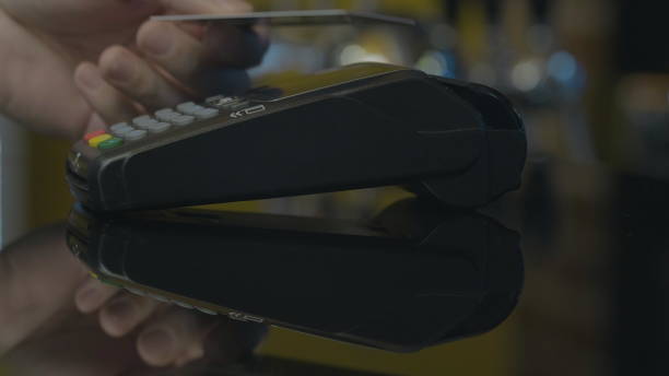 istock Close-up shot of person using mobile payment PayPass. 1164910561