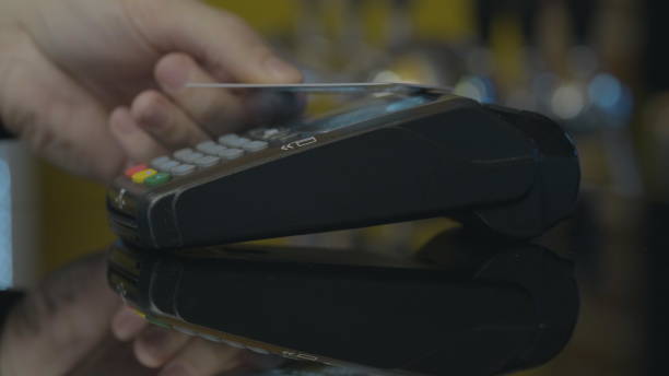 istock Close-up shot of person using mobile payment PayPass. 1164910578