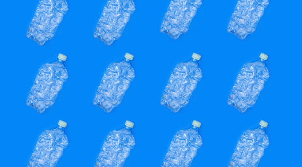 istock Pattern of transparent plastic bottles on blue background. 1164911631