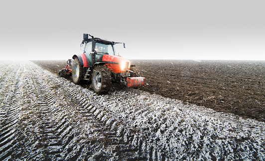 Tractor plowing a field in winter