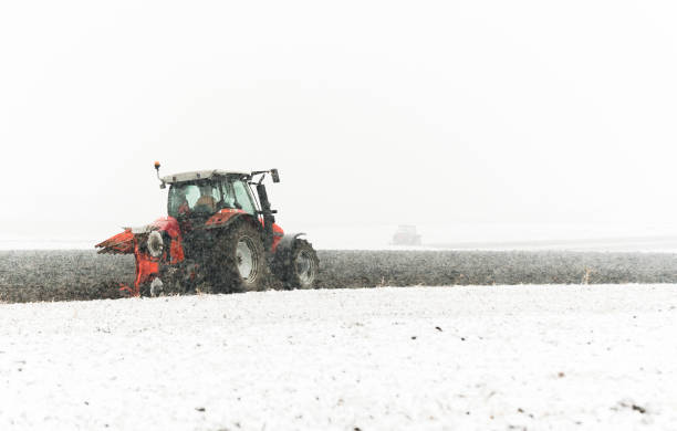 istock Tractor plowing a field in winter 1164913121