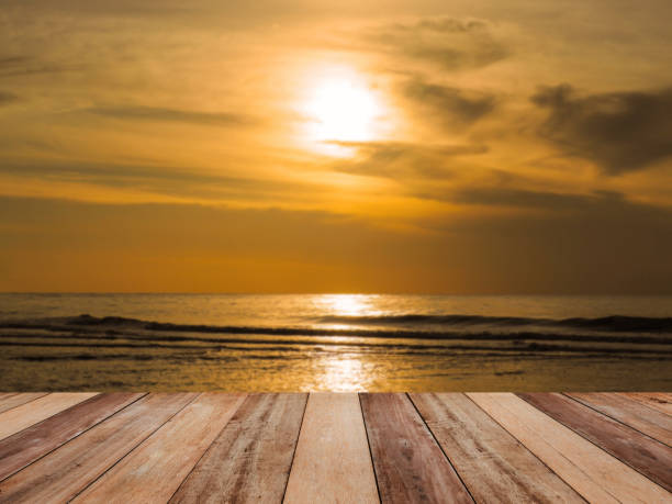 istock Wood table top over sunrise sea 1164913480