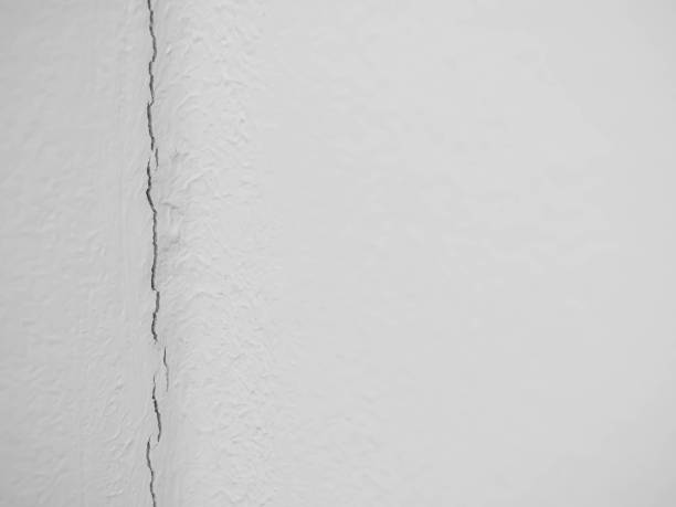 istock Abstract cement or concrete texture with vertical cracked or damaged wall. 1164914564