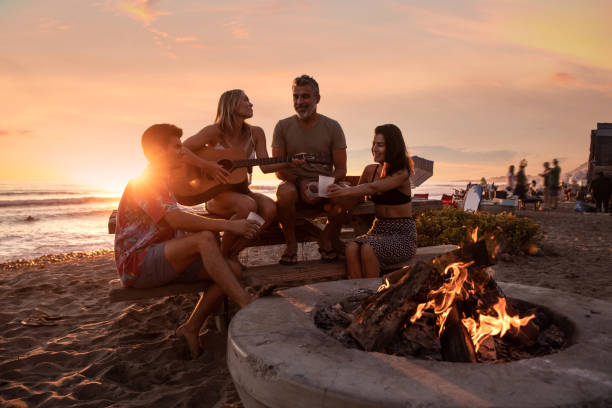 family party on the beach in california at sunset - friendly fire imagens e fotografias de stock