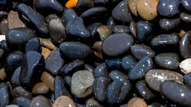 istock Black Volcanic Stones at Mavra Volia Beach 1164915368