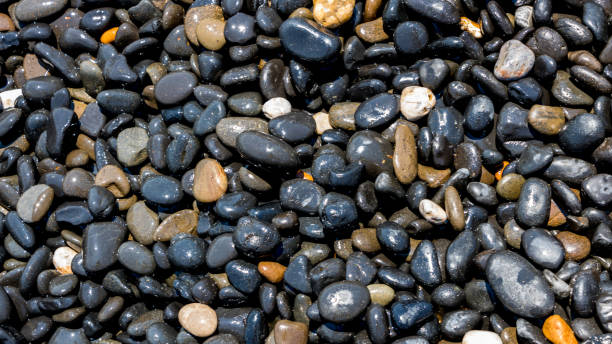 istock Black Volcanic Stones at Mavra Volia Beach 1164915370