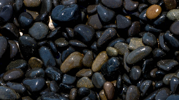 istock Black Volcanic Stones at Mavra Volia Beach 1164915371