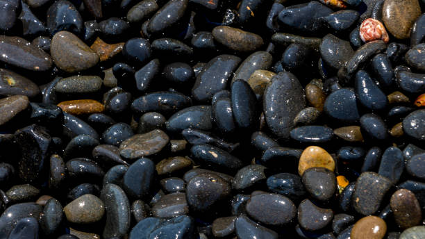 istock Black Volcanic Stones at Mavra Volia Beach 1164915372