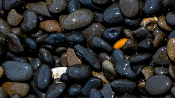 istock Black Volcanic Stones at Mavra Volia Beach 1164915377