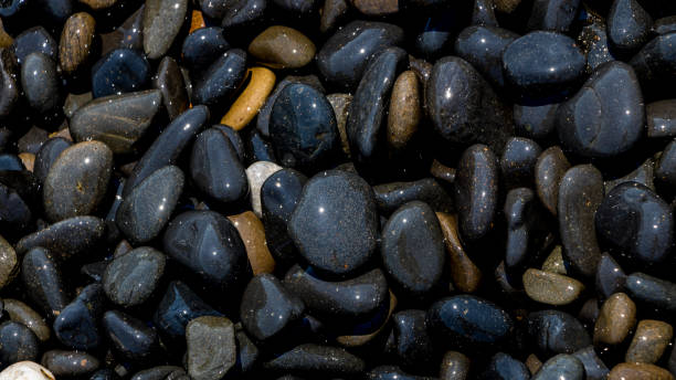 istock Black Volcanic Stones at Mavra Volia Beach 1164915379