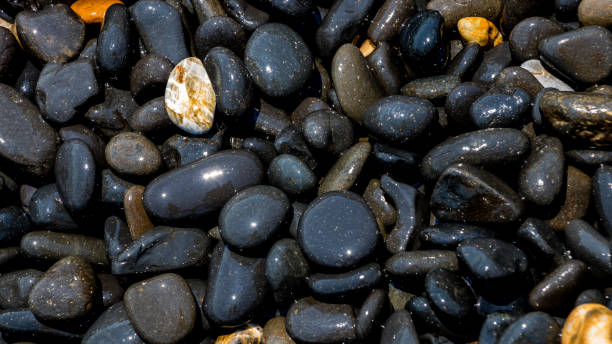 istock Black Volcanic Stones at Mavra Volia Beach 1164915448