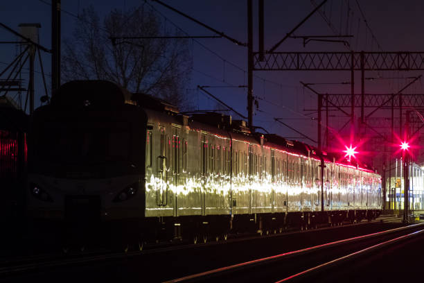 istock A suburban train standing at night on a siding. 1164916995