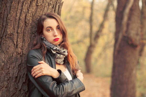 istock woman near tree 1164920371