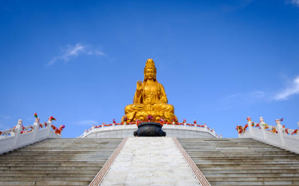 Sitting statue of The Goddess of Compassion and Mercy Sitting statue of The Goddess of Compassion and Mercy, Guanyin at Temple kannon bosatsu stock pictures, royalty-free photos & images