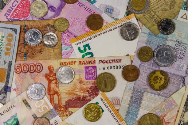 istock Background of banknotes and coins from different countries 1164922635