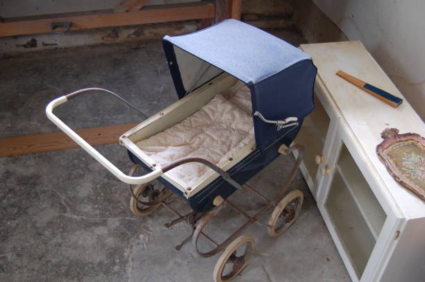 The pram is rusty and standing in a rustic room.