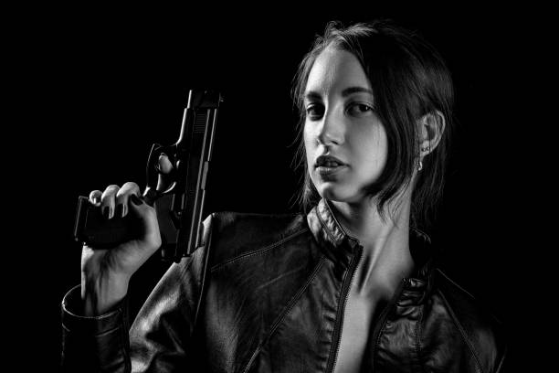 istock girl with gun 1164923052