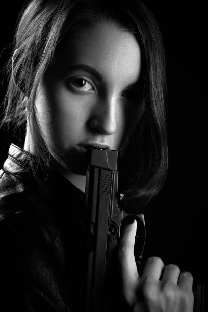 istock girl with gun 1164923611